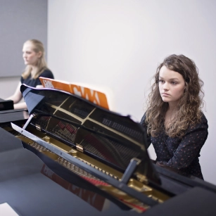 female student playing piano