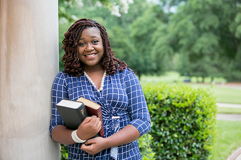 student holding book