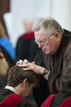 Professor Bray blessing a student