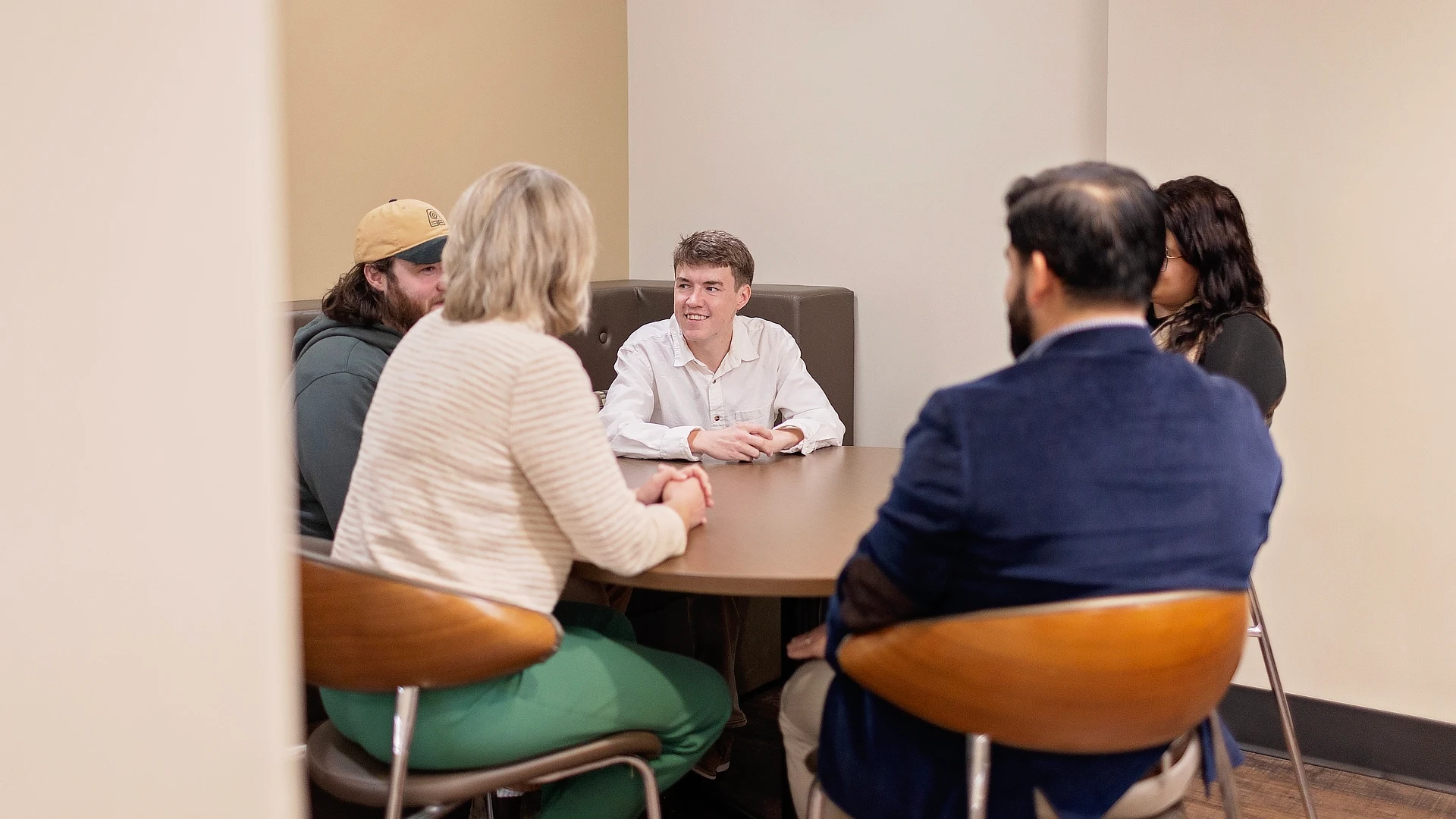 four divinity students sitting at a table