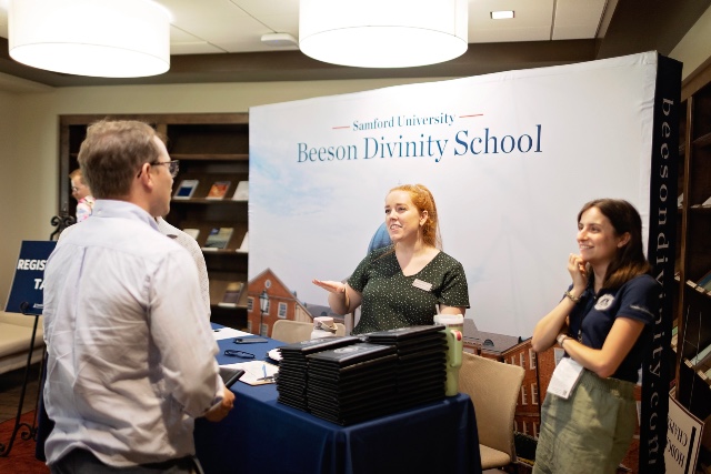 Beeson staff members Anna Russell and Emily Knight greet alumni at the 2025 Preaching Conference.