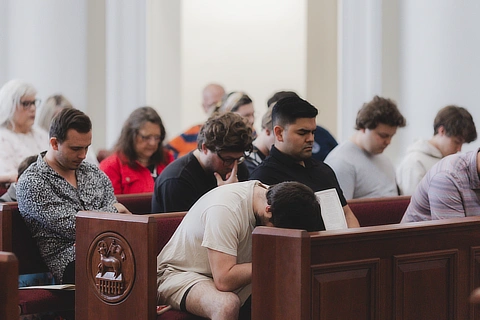 students praying in chapel