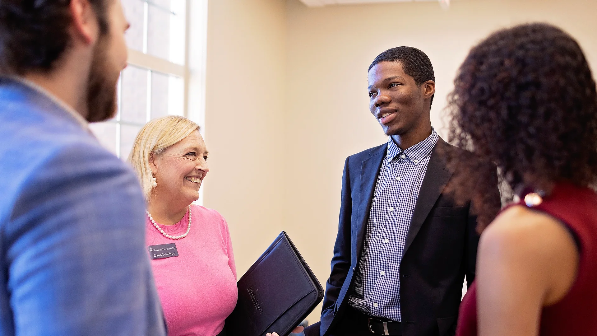 adviser with students in the hallway