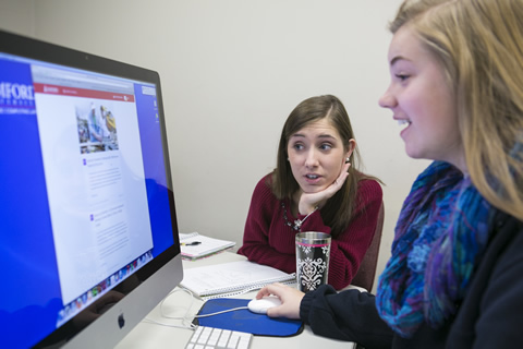 Two female students looking at a computer screen