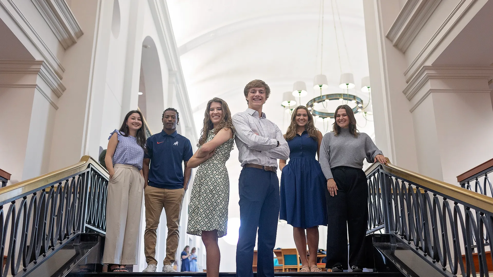 six students standing at the top of stairs