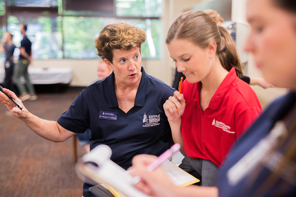 Professor Margaret Johnson instructing a graduate student