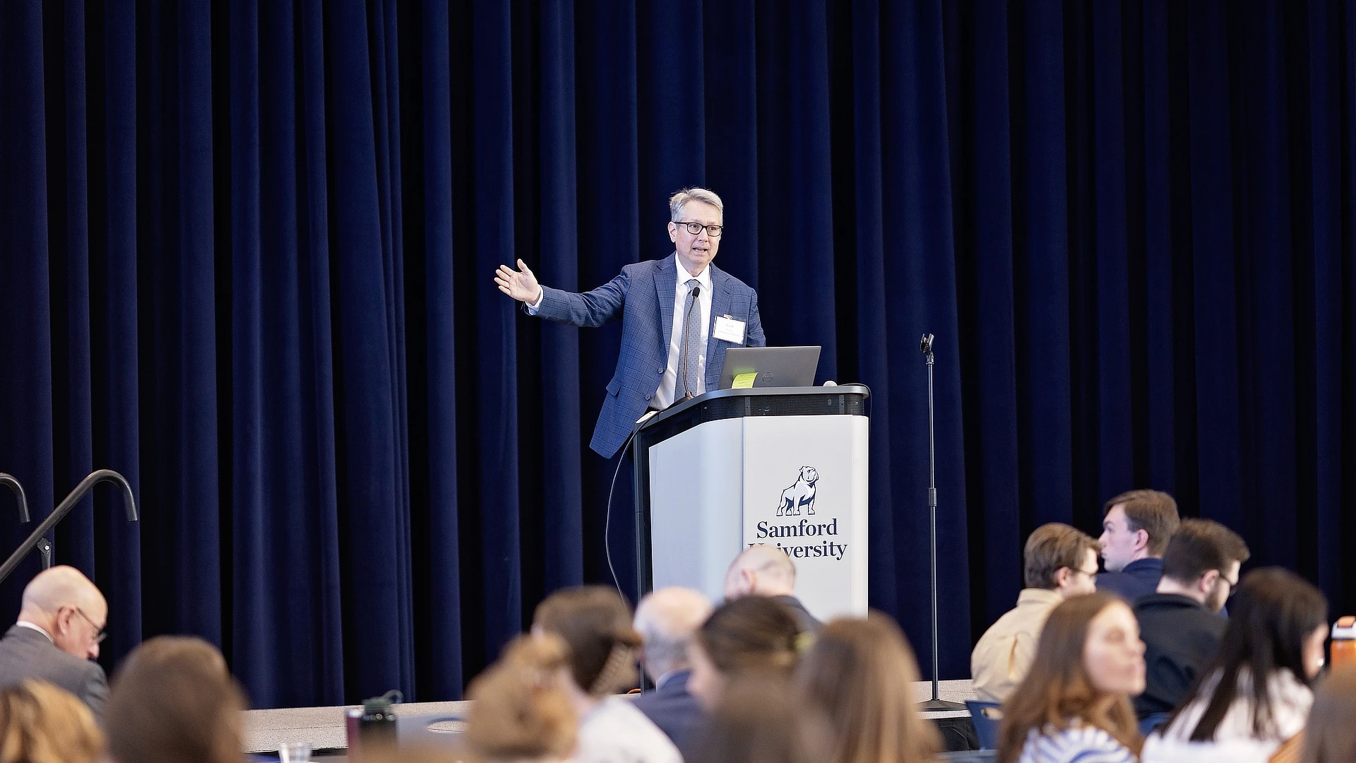 man speaking at the conference