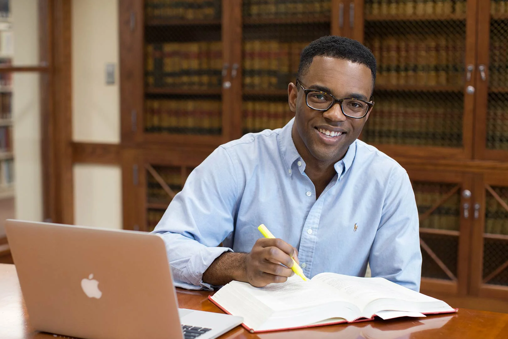 male student highlighting textbook