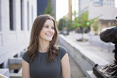 smiling woman outside courthouse DR07162022284 480x320