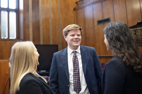 three law stuents in a court room