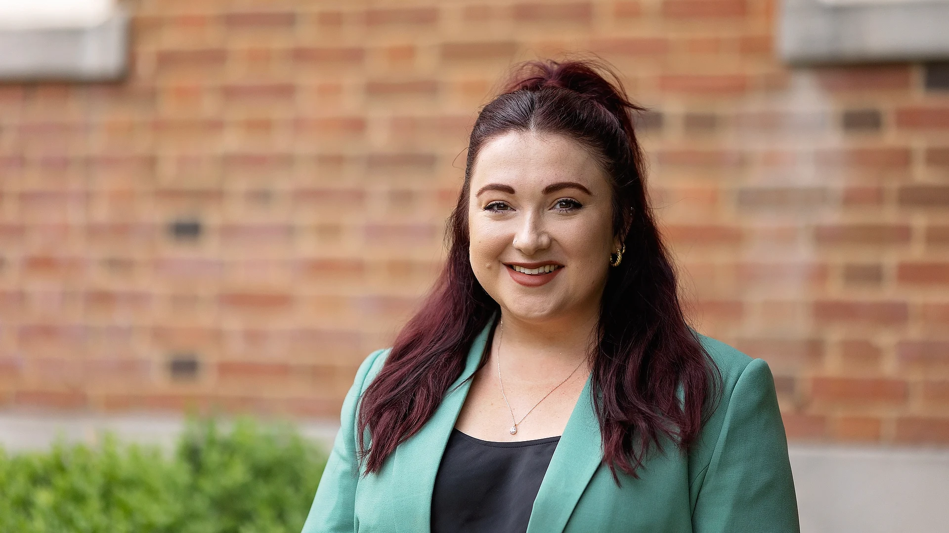 female law student in a green jacket