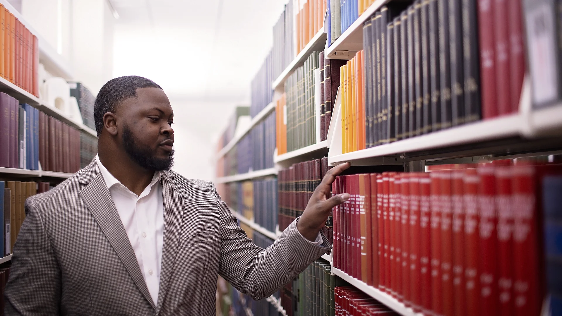 male student browsing shelves