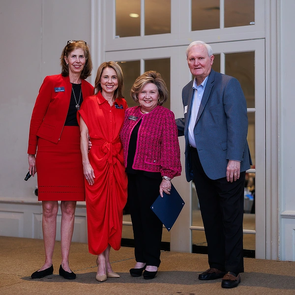 four people standing together
