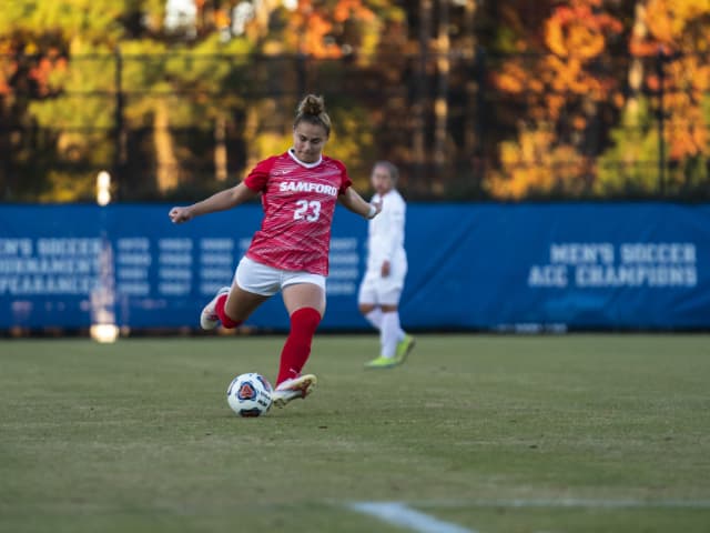 Female Soccer Player Kicking Ball