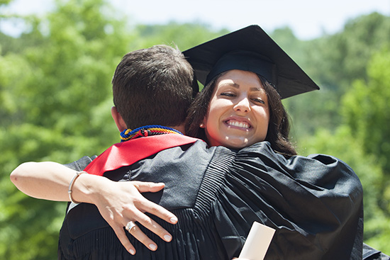 graduates hugging