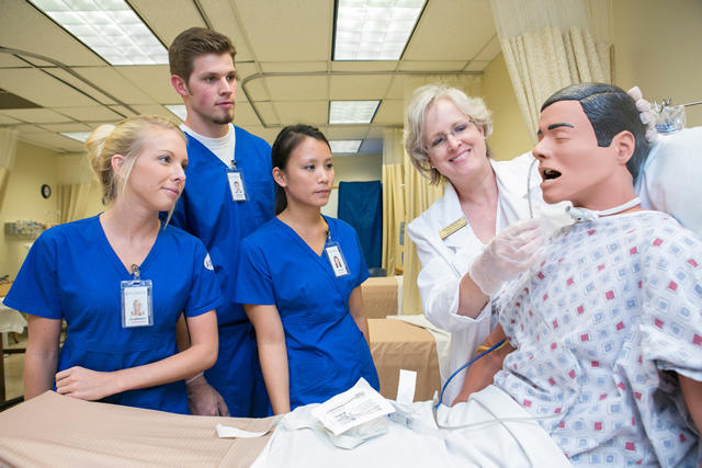 nursing instructor demonstrating simulation to students