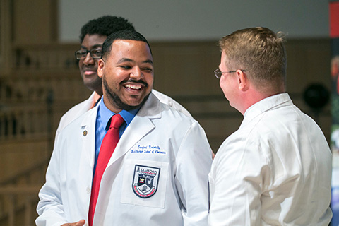 student happy getting pharmacy coat