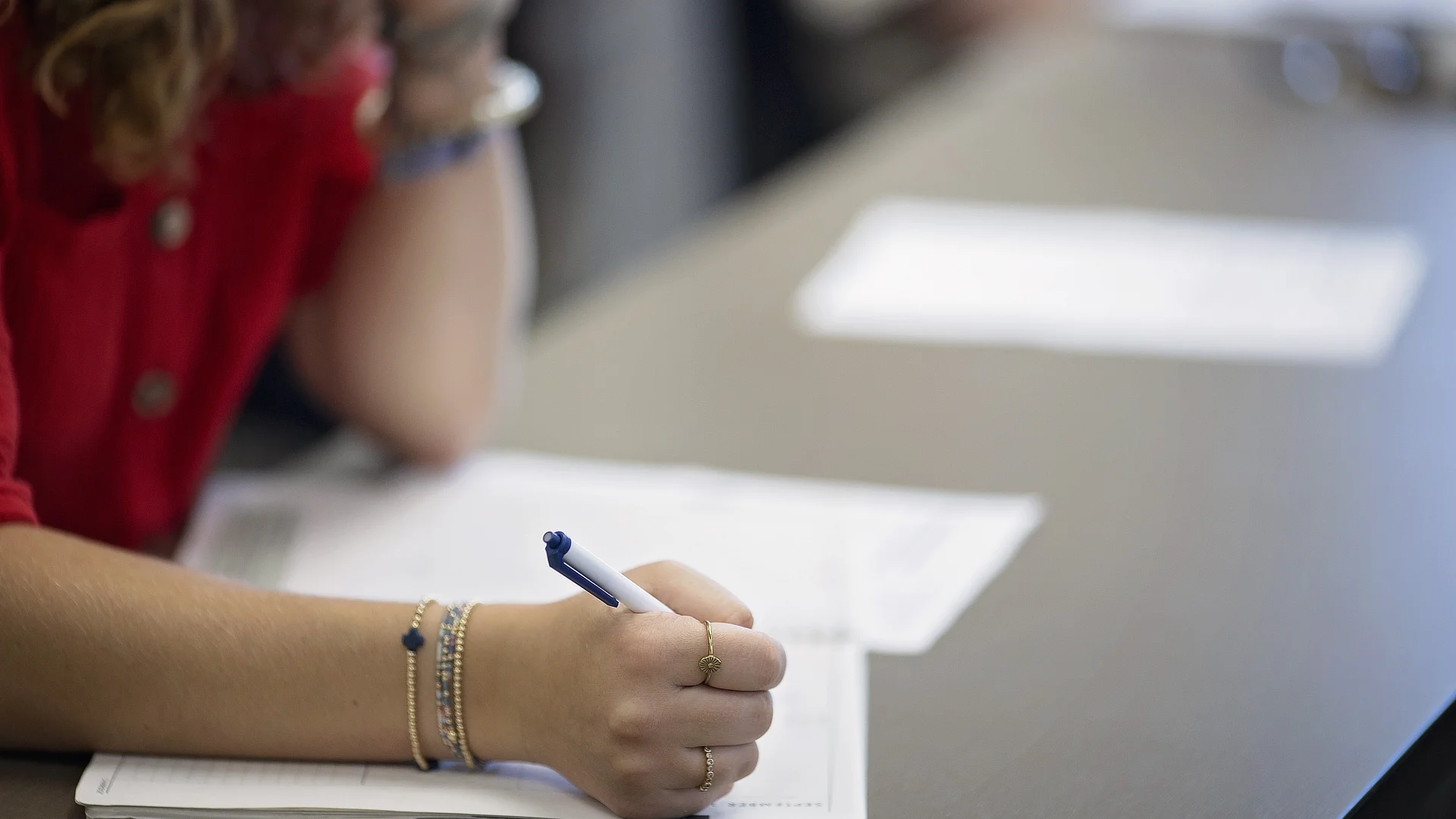 female student taking notes