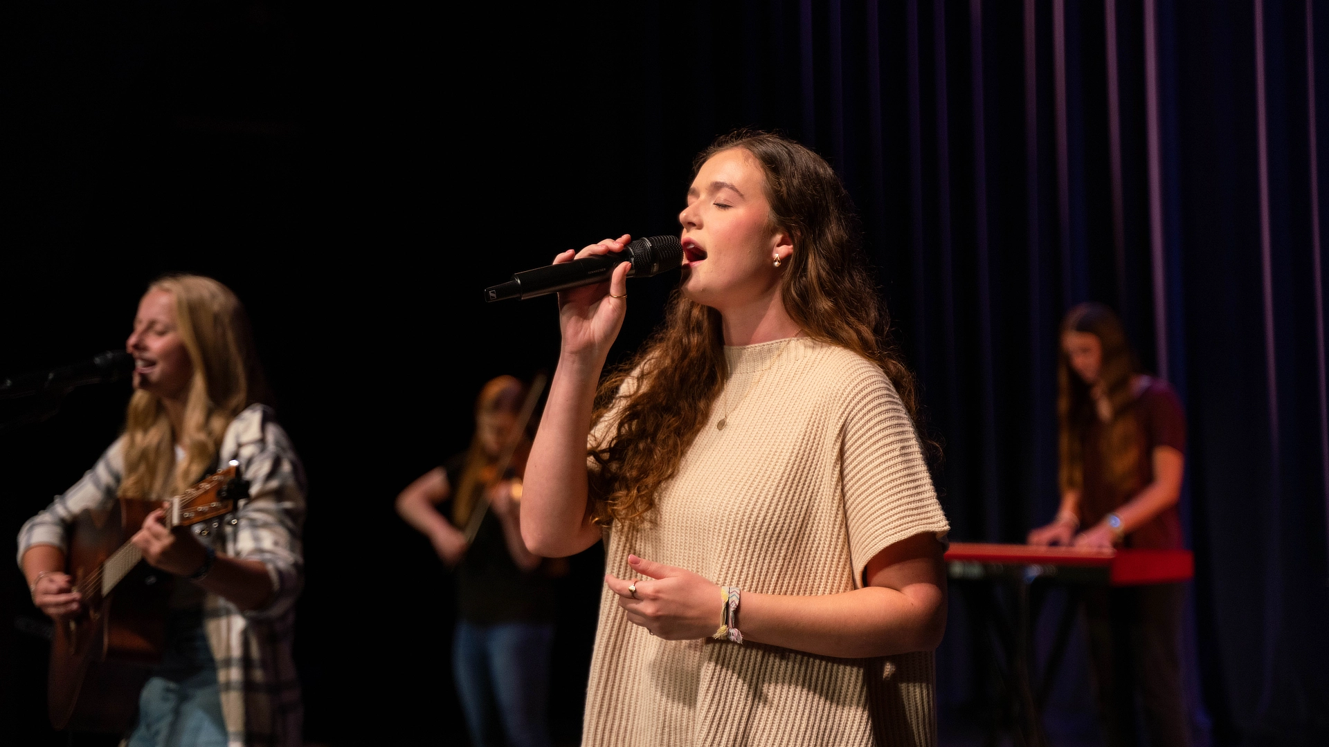 female student leading worship