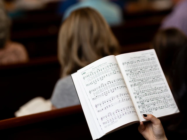 hymnal being held in worship services