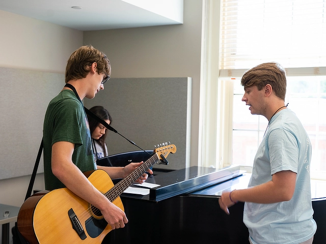 rehearsing for worship with voice guitar and piano