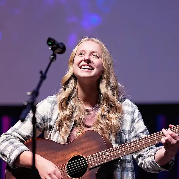 female student singer with guitar